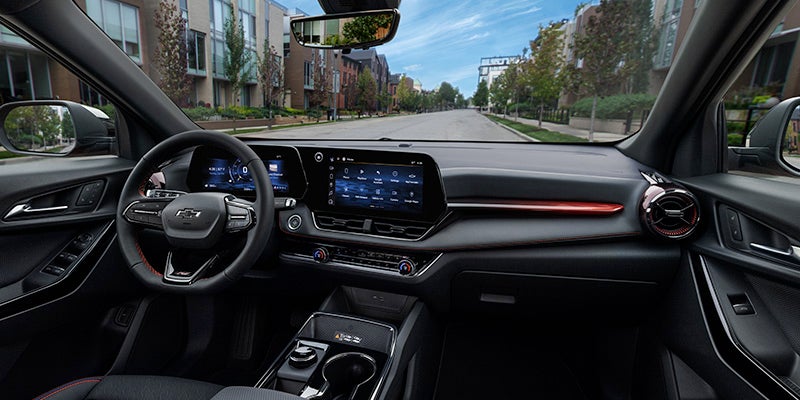 Close up view of 2025 Chevy Equinox front dashboard from the front passengers point of view. Steering wheel, temperature controls, and touch screen are visible.