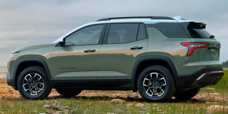 Rear side view of 2025 Chevy Equinox near a body of water