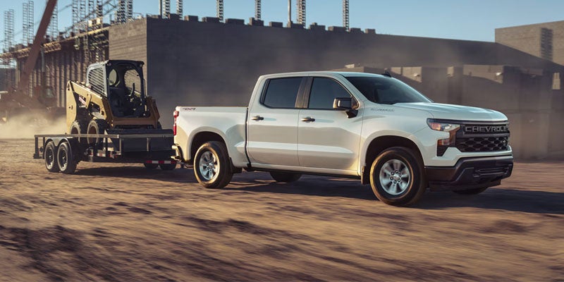 Front view of the 2025 Chevrolet Silverado driving up a dirt mountain road