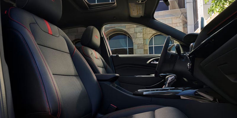 Close up view of the 2025 Chevy Trax's center console where a smartphone is charging wirelessly.