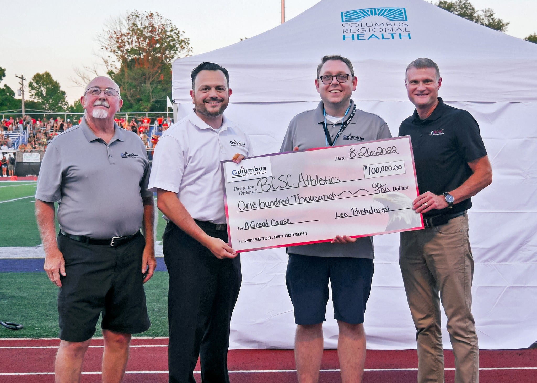Leo Portaluppi presenting a $100,000 check to BCSC Athletics at a Columbus Indiana community event