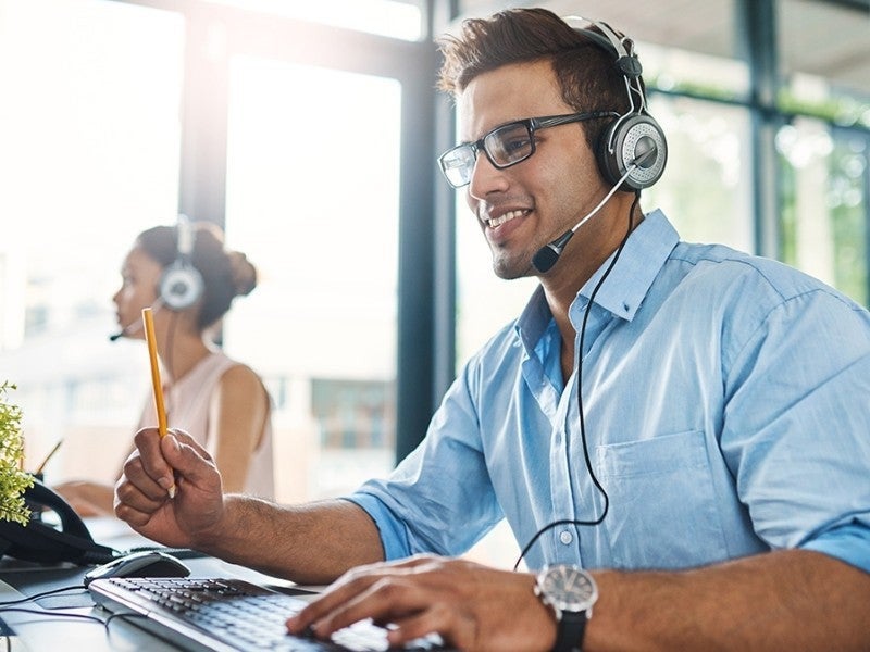 man talking to customer with wearing headphones